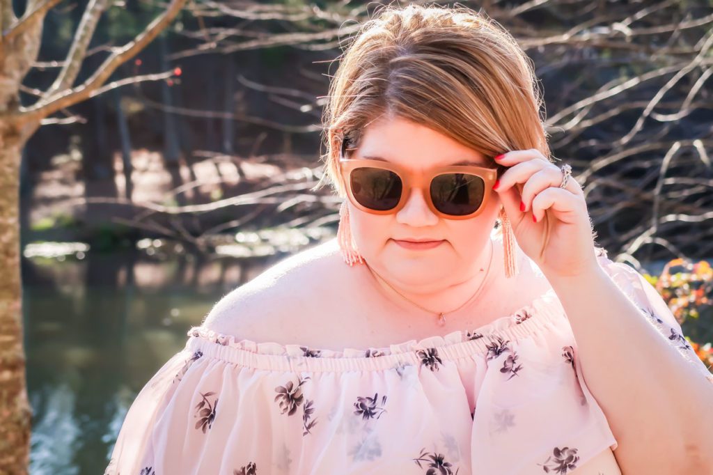 Girl wearing Lane Bryant Off The Shoulder Ruffled Maxi Dress holding sunglasses