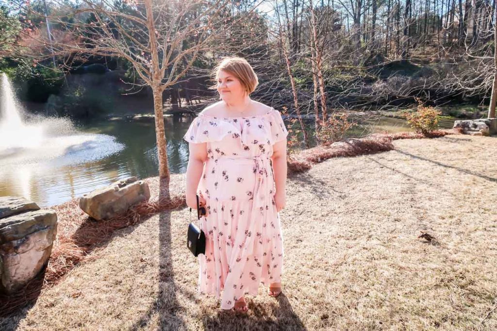 Lane Bryant Off The Shoulder Ruffled Maxi Dress in front of pond with fountain 