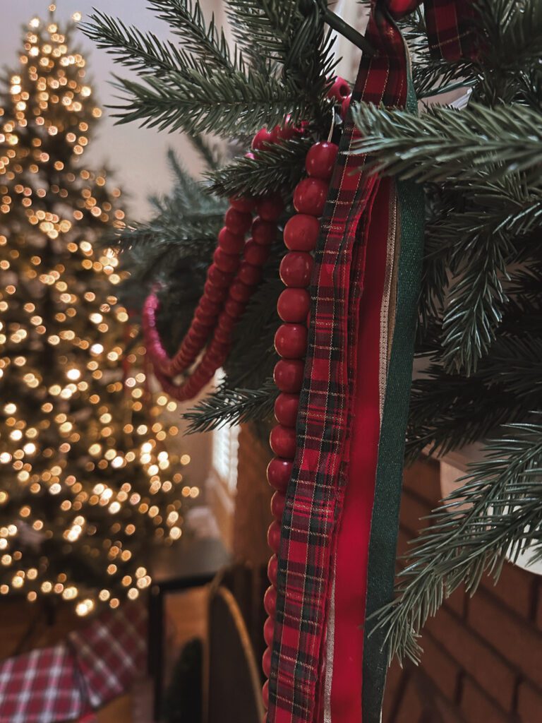 Holiday decorating with Christmas tree lights glowing in living room
